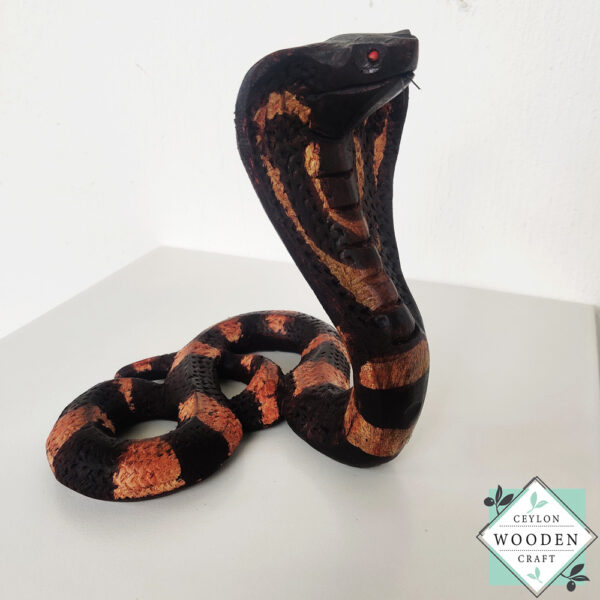 Hand-carved mahogany snake statue symbolizing rebirth and immortality. A unique, eco-friendly decor piece for boho, spiritual, or witchy spaces.