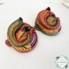 Inspired by Sri Lanka’s traditional Bihiri Sanni masks, this hand-carved and hand-painted wooden snake mask brings boho charm and cultural depth to any wall space.