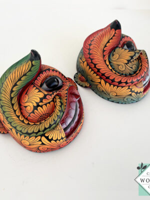 Inspired by Sri Lanka’s traditional Bihiri Sanni masks, this hand-carved and hand-painted wooden snake mask brings boho charm and cultural depth to any wall space.