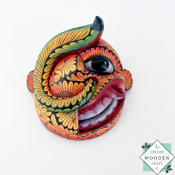 Inspired by Sri Lanka’s traditional Bihiri Sanni masks, this hand-carved and hand-painted wooden snake mask brings boho charm and cultural depth to any wall space.