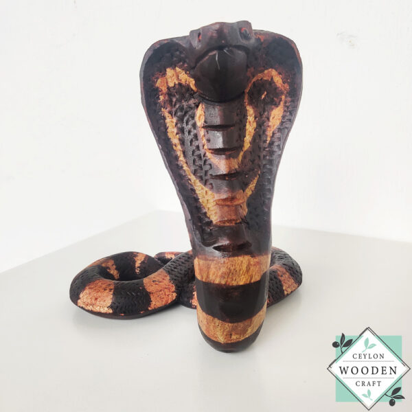 Hand-carved mahogany snake statue symbolizing rebirth and immortality. A unique, eco-friendly decor piece for boho, spiritual, or witchy spaces.