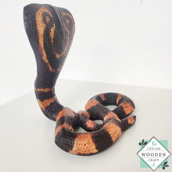 Hand-carved mahogany snake statue symbolizing rebirth and immortality. A unique, eco-friendly decor piece for boho, spiritual, or witchy spaces.