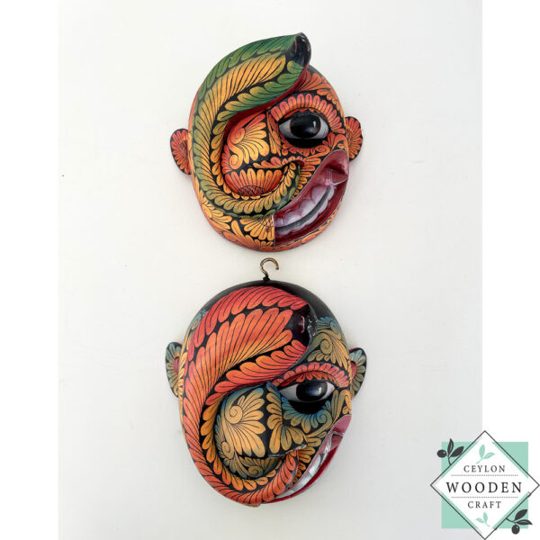 Inspired by Sri Lanka’s traditional Bihiri Sanni masks, this hand-carved and hand-painted wooden snake mask brings boho charm and cultural depth to any wall space.