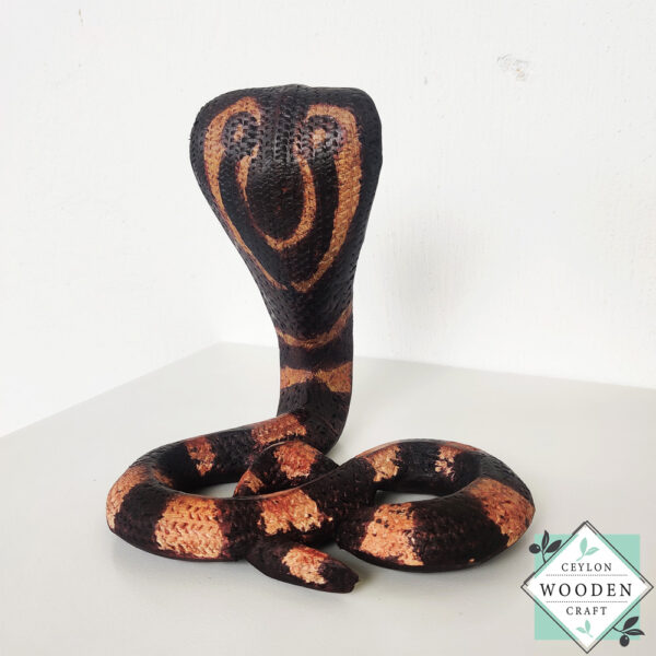 Hand-carved mahogany snake statue symbolizing rebirth and immortality. A unique, eco-friendly decor piece for boho, spiritual, or witchy spaces.