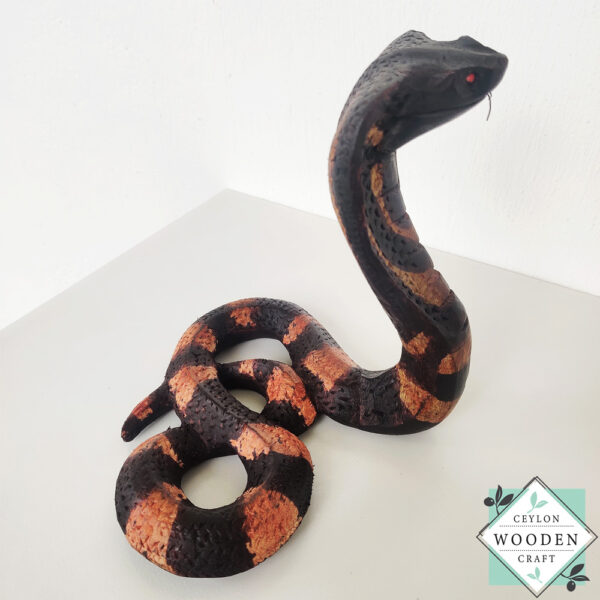 Hand-carved mahogany snake statue symbolizing rebirth and immortality. A unique, eco-friendly decor piece for boho, spiritual, or witchy spaces.