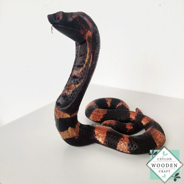 Hand-carved mahogany snake statue symbolizing rebirth and immortality. A unique, eco-friendly decor piece for boho, spiritual, or witchy spaces.