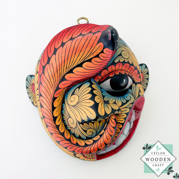 Inspired by Sri Lanka’s traditional Bihiri Sanni masks, this hand-carved and hand-painted wooden snake mask brings boho charm and cultural depth to any wall space.