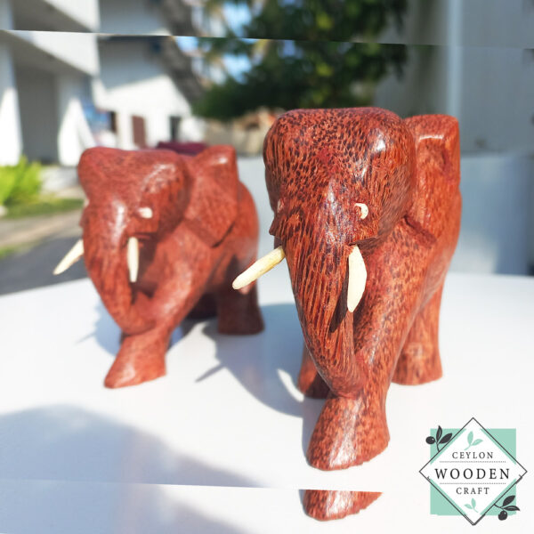 hand-carved coconut wood Set of two elephant figures with tusks. Handmade in Sri Lanka. Perfect for gifts, decor, or meaningful souvenirs.