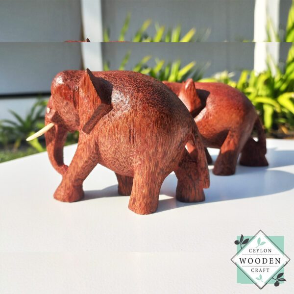 hand-carved coconut wood Set of two elephant figures with tusks. Handmade in Sri Lanka. Perfect for gifts, decor, or meaningful souvenirs.