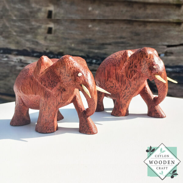 hand-carved coconut wood Set of two elephant figures with tusks. Handmade in Sri Lanka. Perfect for gifts, decor, or meaningful souvenirs.