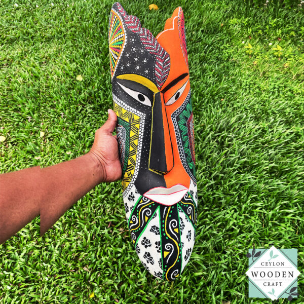 Hand-carved tribal mask made from kaduru wood. Colorful, lightweight, and perfect for boho or ethnic home decor. Available in 3 sizes.