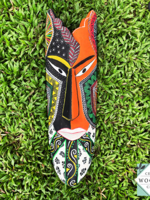 Hand-carved tribal mask made from kaduru wood. Colorful, lightweight, and perfect for boho or ethnic home decor. Available in 3 sizes.