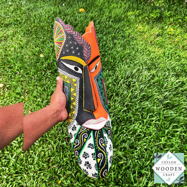 Hand-carved tribal mask made from kaduru wood. Colorful, lightweight, and perfect for boho or ethnic home decor. Available in 3 sizes.