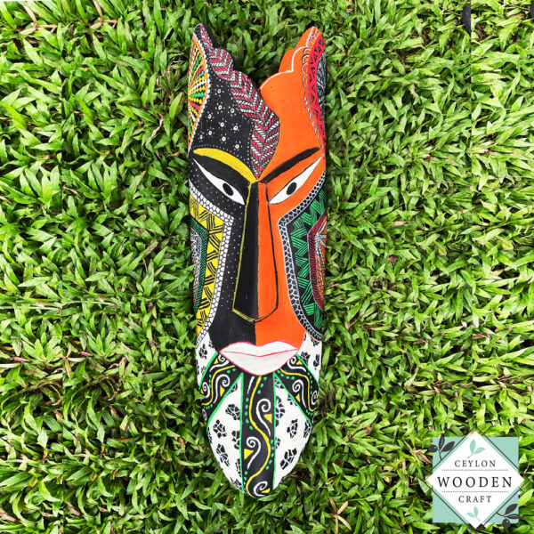 Hand-carved tribal mask made from kaduru wood. Colorful, lightweight, and perfect for boho or ethnic home decor. Available in 3 sizes.