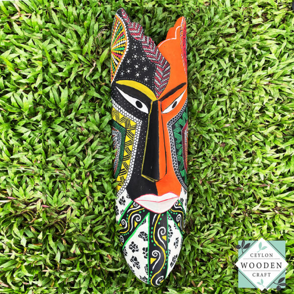 Hand-carved tribal mask made from kaduru wood. Colorful, lightweight, and perfect for boho or ethnic home decor. Available in 3 sizes.