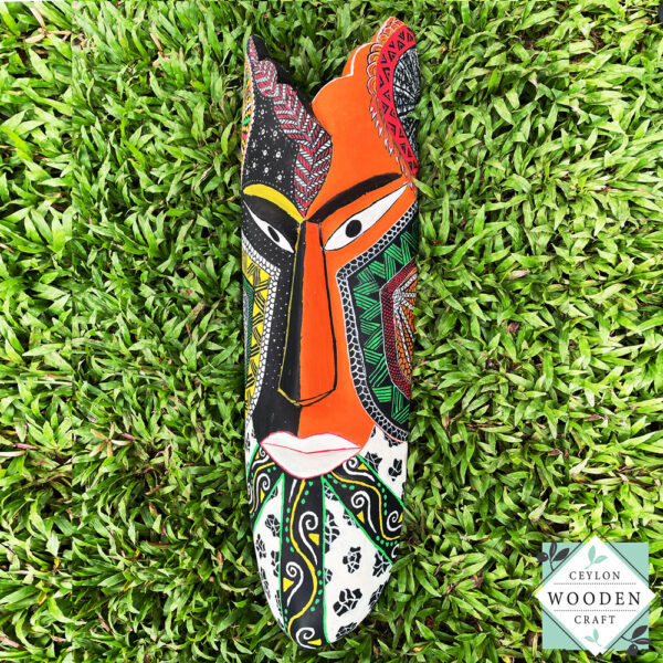 Hand-carved tribal mask made from kaduru wood. Colorful, lightweight, and perfect for boho or ethnic home decor. Available in 3 sizes.