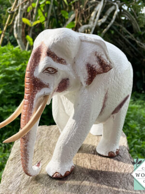 This hand-carved wooden white elephant sculpture features fine detailing and elegant tusks. A beautiful, eco-friendly decor piece and a meaningful gift for any occasion.