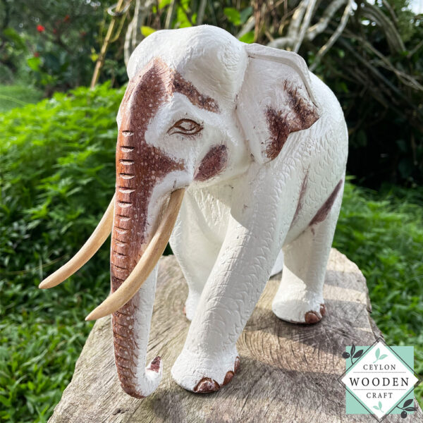 This hand-carved wooden white elephant sculpture features fine detailing and elegant tusks. A beautiful, eco-friendly decor piece and a meaningful gift for any occasion.