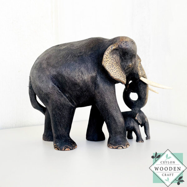 Hand-carved mahogany elephant mother and baby sculpture. Symbolizes love, luck, and strength. A perfect handmade gift or decorative accent.