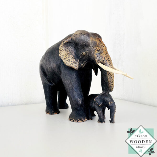 Hand-carved mahogany elephant mother and baby sculpture. Symbolizes love, luck, and strength. A perfect handmade gift or decorative accent.