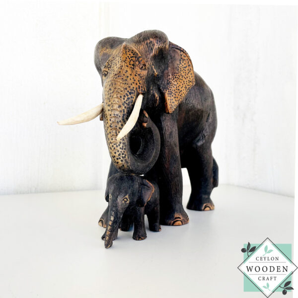 Hand-carved mahogany elephant mother and baby sculpture. Symbolizes love, luck, and strength. A perfect handmade gift or decorative accent.