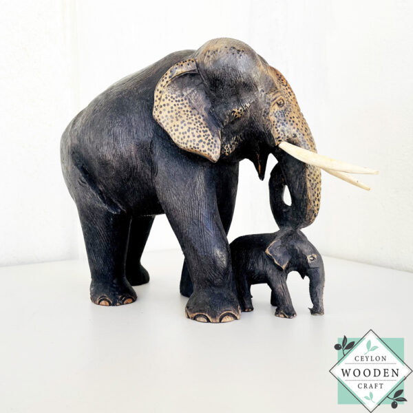 Hand-carved mahogany elephant mother and baby sculpture. Symbolizes love, luck, and strength. A perfect handmade gift or decorative accent.