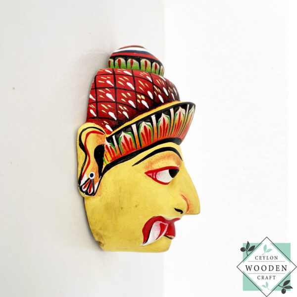 Authentic Ceylon Sanni mask - handcrafted yellow wooden cultural wall decor from Sri Lanka. Traditional Dewa Sanni healing mask by skilled artisans. Collectible art.