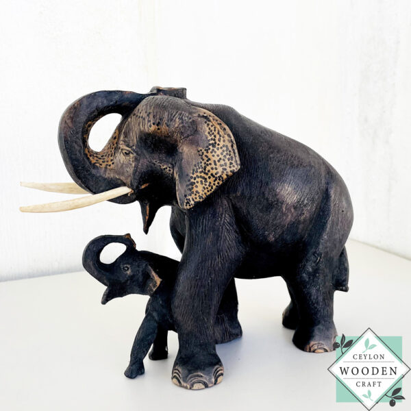 This hand-carved mahogany elephant mother with baby sculpture symbolizes love, protection, and good fortune—perfect for heartfelt gifting or home decor.